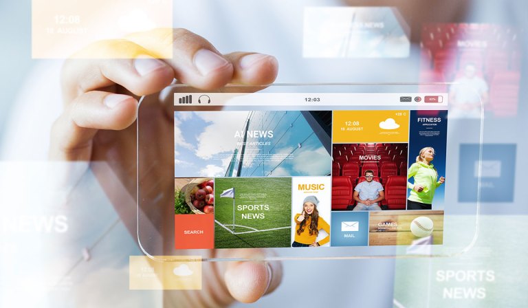 A hand holding a transparent smartphone. The screen displays a colorful interface divided into tiles with different categories and images. The categories visible include 'AI NEWS' with a background of a high-rise building facade, 'FITNESS' showing a woman stretching, 'SPORTS NEWS' featuring a corner of a soccer field, 'MUSIC' with a female DJ, 'MOVIES' with a man in a cinema, and 'GAMES' displaying a baseball. The interface also shows a 'SEARCH' button, and there are time, date, weather, and battery indicators at the top of the screen.