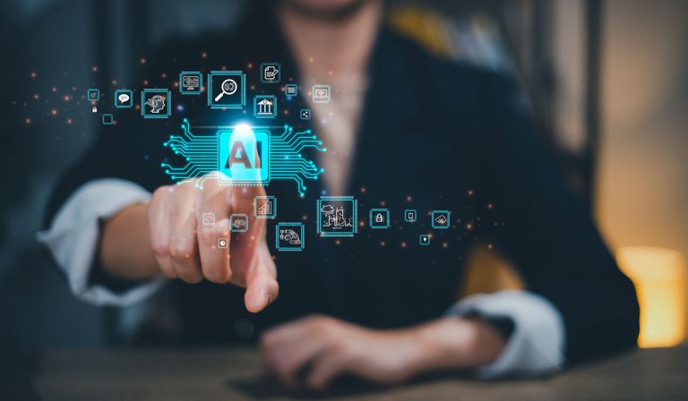 The image depicts a person in business attire reaching out towards a holographic display of various icons and symbols related to artificial intelligence (AI). Central to the display is an AI symbol, surrounded by other digital icons representing data analytics, technology, and automation processes, all connected by circuit-like lines, suggesting the integration of AI with various aspects of business and technology.