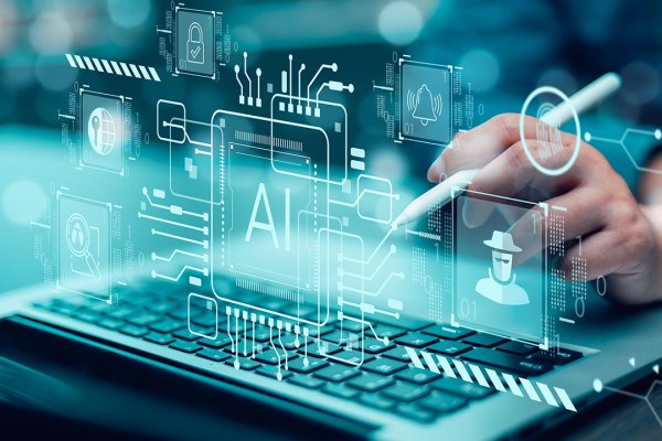 A close-up of a person using a laptop with a stylus, overlaid with a futuristic digital interface featuring AI-related icons. The interface includes a central AI microchip graphic surrounded by symbols such as a padlock, a hacker in a hat, a magnifying glass inspecting code, and a globe with a key, all connected by circuit-like lines. The image has a cyan-blue color scheme, representing technology, cybersecurity, and artificial intelligence concepts.